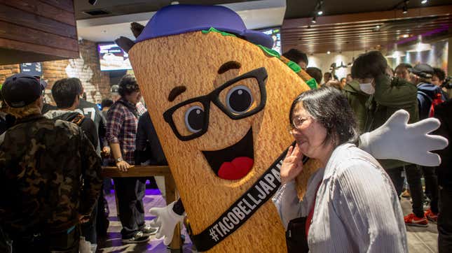 A Taco Bell mascot poses during a grand opening in 2015.