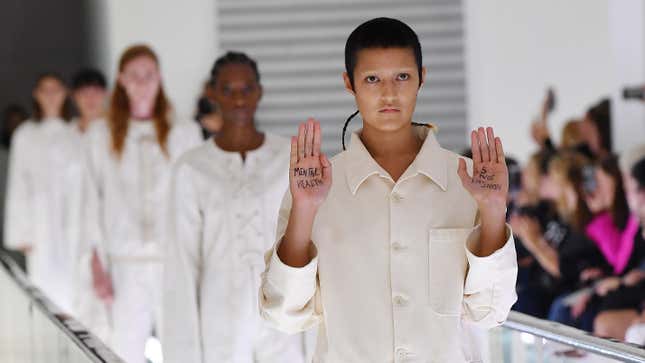 Model Ayesha Tan-Jones protests as models walk the runway at the Gucci Spring/Summer 2020 fashion show during Milan Fashion Week on Sept. 22, 2019, in Milan, Italy.