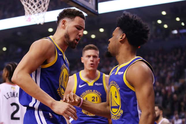 Klay Thompson, left, and Quinn Cook, right, of the Golden State Warriors celebrate the play against the Toronto Raptors.