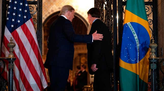 President Donald Trump (L) greets Brazilian President Jair Bolsonaro during a dinner at Mar-a-Lago in Palm Beach, Florida, on March 7, 2020.