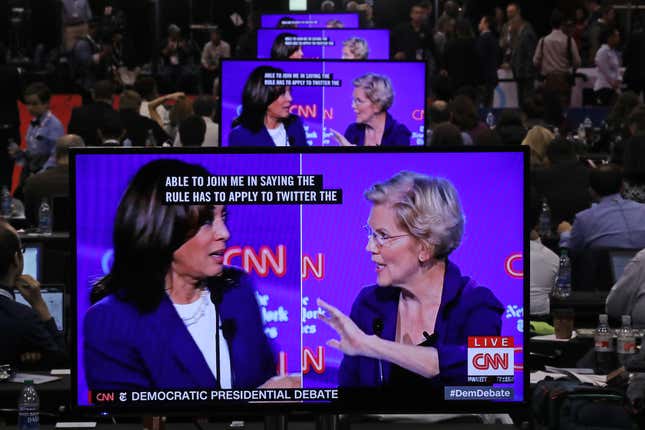 Sen. Kamala Harris (D-CA) and Sen. Elizabeth Warren (D-MA) appear on television screens in the Media Center as they go back and forth during the Democratic Presidential Debate at Otterbein University on October 15, 2019, in Westerville, Ohio. 