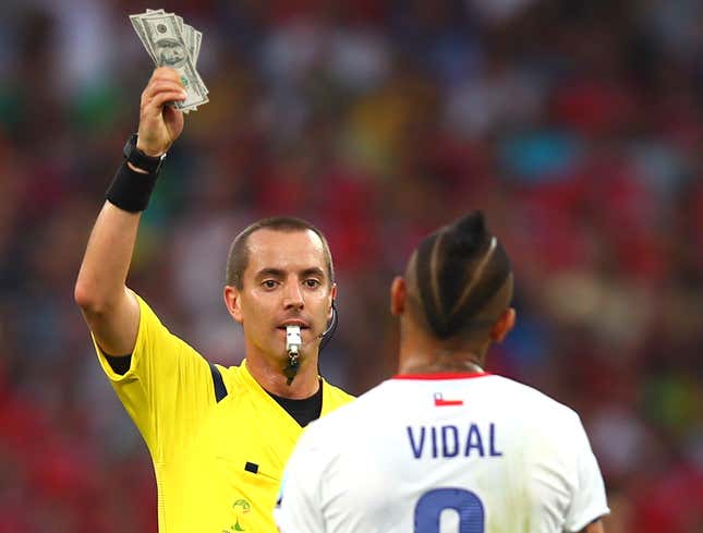 Image for article titled World Cup Referee Accidentally Grabs Stack Of Hundreds Instead Of Yellow Card