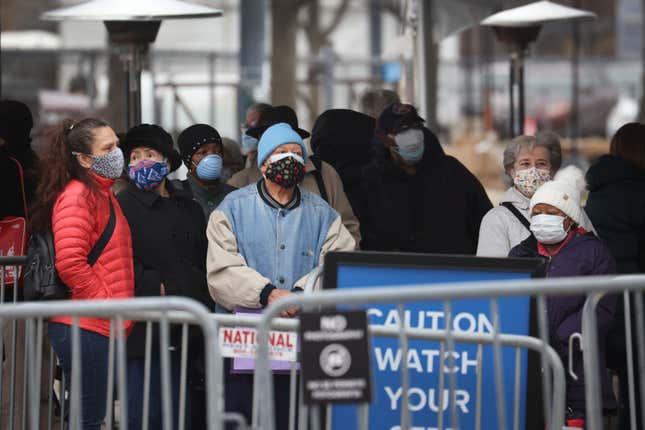  Residents wait in line to be vaccinated at a mass COVID-19 vaccination center set up in a parking lot outside of the United Center, home to the Chicago Bulls and Blackhawks, on March 10, 2021 in Chicago, Illinois.