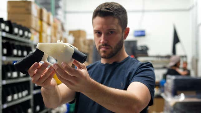 Cody Wilson, owner of Defense Distributed company, holds a 3D printed gun, called the “Liberator”, in his factory in Austin, Texas on Aug. 1, 2018. 