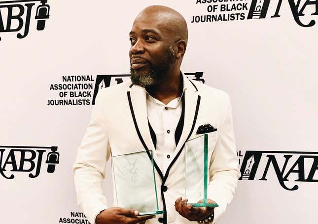 The Root’s Michael Harriot, cradling dual awards at the 2019 NABJ Awards.