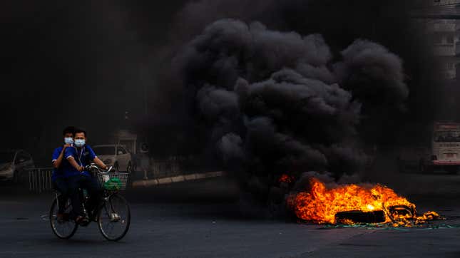  Smoke rises from tires set alight by anti-coup protesters on April 03, 2021 in Yangon, Myanmar.