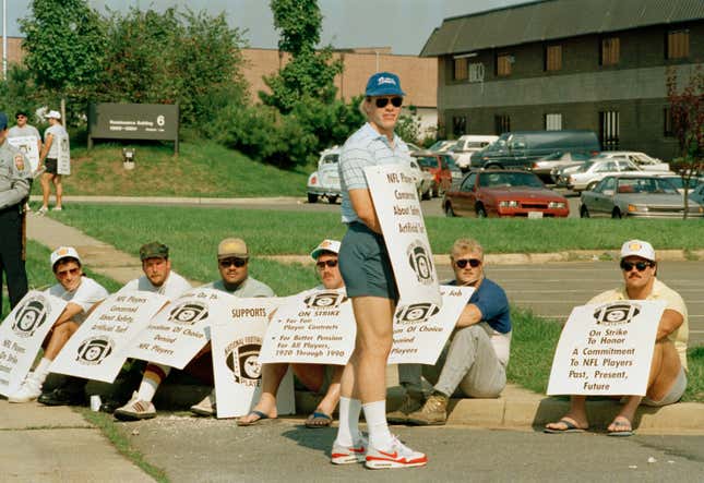 Quarterback Jay Schroeder (standing) and several Washington teammates on a picket line. (Dennis Cook/AP Photo)