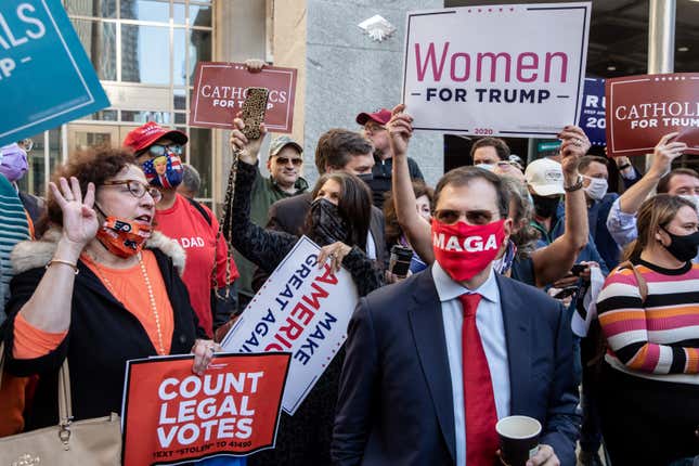 Supporters of U.S. president Donald Trump hold signs and chant slogans during a protest outside the Philadelphia Convention center as votes continue to be counted following the 2020 U.S. presidential election on November 5, 2020 in Philadelphia, Pennsylvania. 