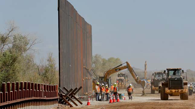 Government contractors erect a section of the border wall along the Colorado River in Yuma, Arizona, back in September 2019.