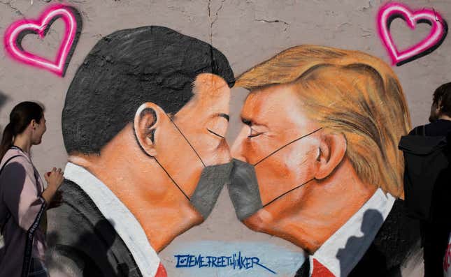  Street art shows US President Donald Trump and Chinese President Xi Jinping wearing protective mask and kissing at a section of the former Berlin Wall at Mauerpark during the novel coronavirus crisis on April 26, 2020 in Berlin, Germany. Germany is taking its first steps to ease restrictions on public life that had been imposed weeks ago in order to stem the spread of the coronavirus.