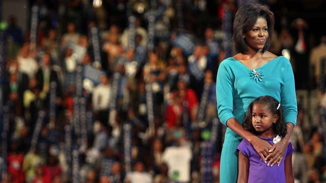 Michelle Obama stands with daughter Sasha onstage during the Democratic National Convention (DNC) on August 25, 2008 in Denver, Colorado.