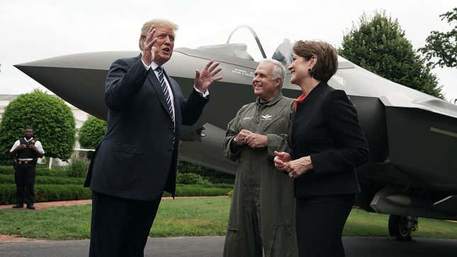 President Donald Trump talks to Chairman, President and CEO of Lockheed Marillyn Hewson and Chief Test Pilot Alan Norman in front of an F-35 fighter jet during the 2018 Made in America Product Showcase July 23, 2018 at the White House in Washington, DC.