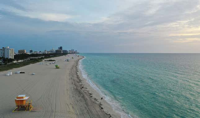 An aerial drone view of the closed South Beach on May 19, 2020 in Miami Beach, Florida. The city of Miami Beach will allow “various retail stores, personal grooming establishments, offices and museums” to open staring tomorrow.