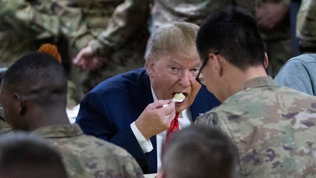 President Donald Trump eating with members of the military in a dining  facility during a surprise Thanksgiving Day visit, Thursday, Nov. 28,  2019, at Bagram Air Field, Afghanistan.