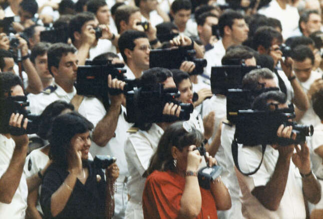 Brazilian sailors filming John Paul II with video cameras during the weekly general audience in the Paul VI audience hall at the Vatican, in Vatican City, on July 6, 1988.
