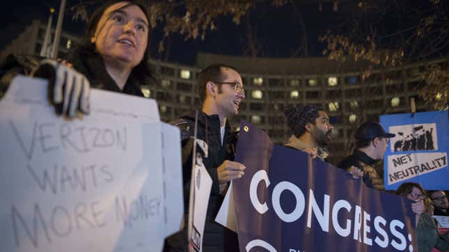 A small group of protesters supporting net neutrality protest against a plan by Federal Communications Commission (FCC) head Ajit Pai, during a demonstration on December 7, 2017 in Washington.