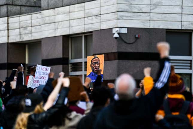 Demonstrators raise their fists as they protest outside the Hennepin County Government Center at the trial of former Minneapolis Police officer Derek Chauvin on March 8, 2021 in Minneapolis, Minnesota. 