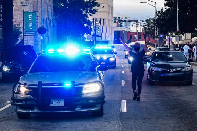 A protestor blocks the traffic outside Georgia State Capitol during a protest on the fifth day following Rayshard Brooks death by police in a restaurant parking lot, in Atlanta, Georgia on June 17, 2020. - An Atlanta police officer has been charged with murder for shooting a 27-year-old man in the back, justice officials announced Wednesday in the latest case to spark anger over police killings of African Americans. 