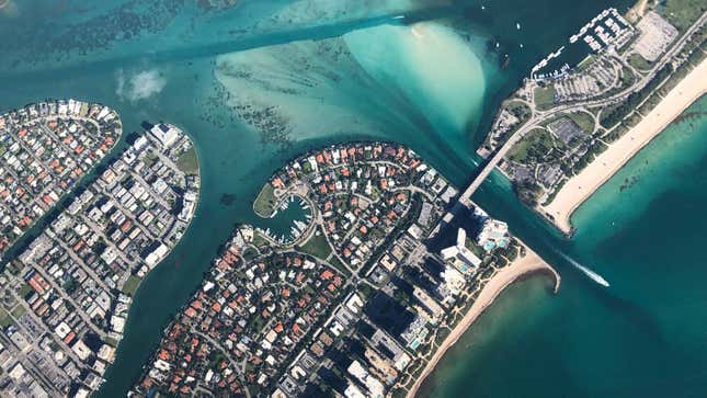 An aerial shot north of Miami showing islands filled with houses, apartments, and other buildings.