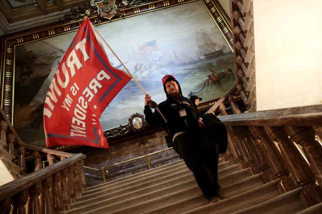 A protester holds a Trump flag inside the US Capitol Building near the Senate Chamber on January 06, 2021 in Washington, DC. Congress held a joint session today to ratify President-elect Joe Biden’s 306-232 Electoral College win over President Donald Trump.