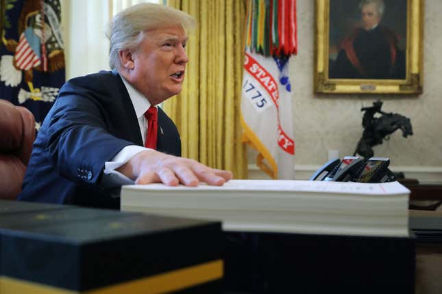 President Donald Trump talks with journalists before signing tax reform legislation into law in the Oval Office December 22, 2017 in Washington, DC. Trump praised Republican leaders in Congress for all their work on the biggest tax overhaul in decades.