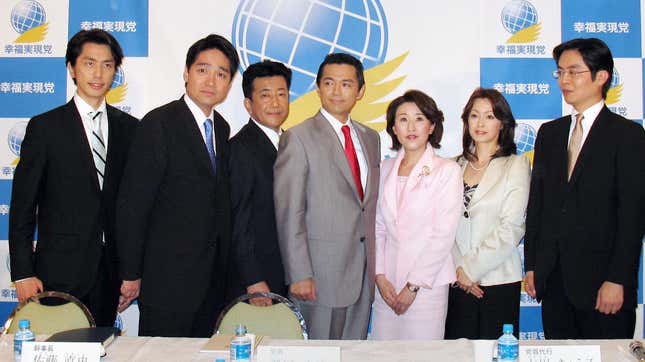 Happiness Realization Party candidates, including Jay Aeba (seen in the gray suit at center), at a Tokyo hotel in 2009. 
