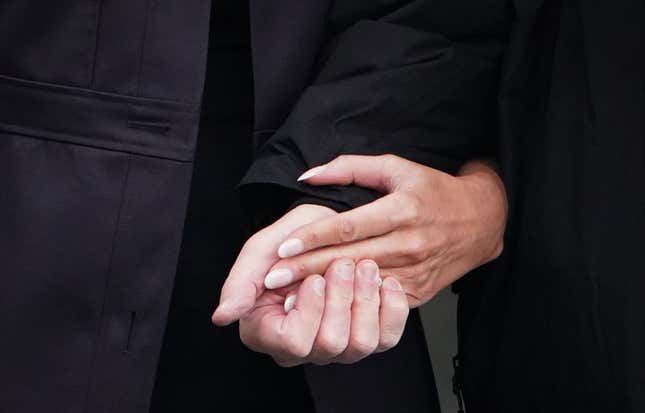 President Donald Trump and first lady Melania Trump kind of hold hands as they make their way to board Marine One from the South Lawn of the White House in Washington, DC on October 15, 2018.