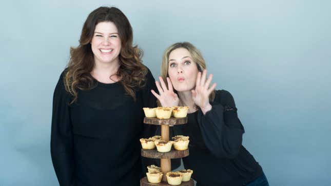 Smith and Parker posing with a three-tiered serving tray of butter tarts [shared with permission]