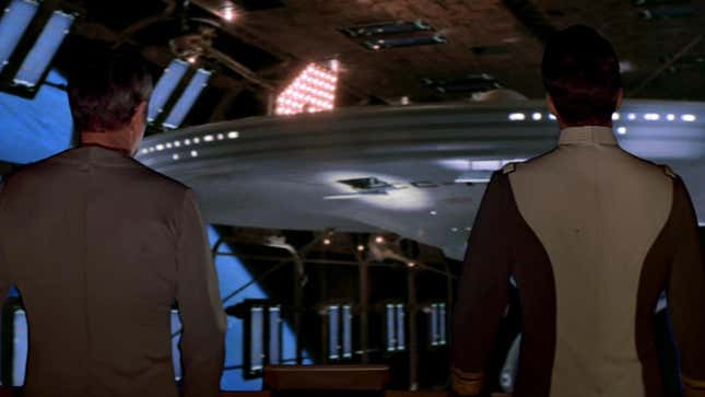Kirk and Scotty examine the reforged Enterprise.