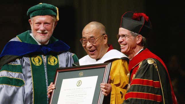 Adobe co-founder and University of San Francisco chairman Charles Geschke (left) presents an honorary degree to the Dalai Lama alongside USF president Steven Privett (right) in San Francisco, California in 2003. 