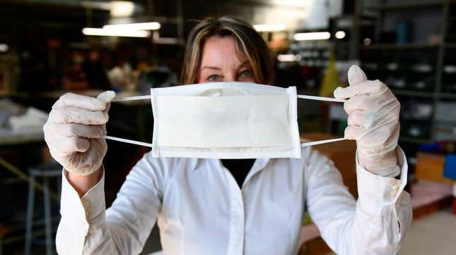 An employee at an Italian leather factory that started producing masks