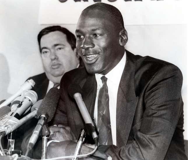 Jerry Krause, left, general manager of the Chicago Bulls, is shown with Bulls legend Michael Jordan in this Sept. 20, 1988 photo after Jordan agreed to an eight-year contract extension. 