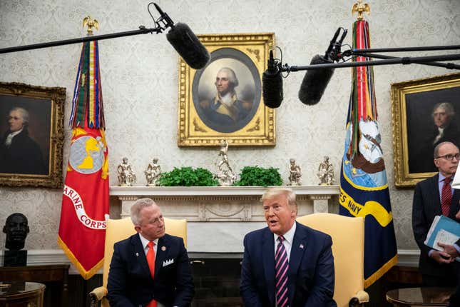 Representative Jeff Van Drew of New Jersey, who has announced he is switching from the Democratic to Republican Party, looks on as U.S. President Donald Trump in the Oval Office of the White House on Dec. 19, 2019, in Washington, D.C. Van Drew voted against the two articles of impeachment yesterday in the House of Representatives.