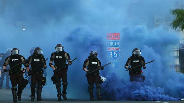 State police advance in a riot line on protesters in Minneapolis on May 30, 2020.