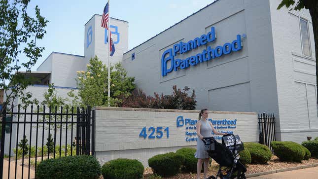 A woman stands with her child in a stroller during an anti-abortion rally in June 2019 outside the Planned Parenthood clinic in St. Louis, Missouri’s lone abortion clinic.