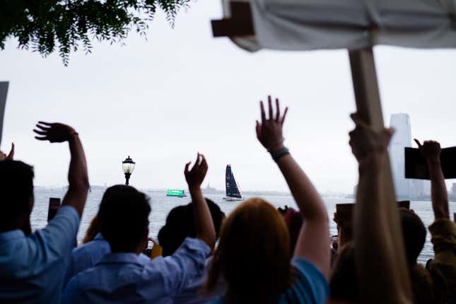 Onlookers wave at Greta Thunberg arriving in New York Harbor.