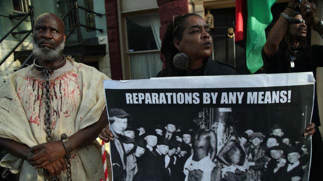 Activists stage a protest July 1, 2019, to mark National Reparations Day outside the Washington, D.C., residence of Senate Majority Leader Mitch McConnell (R-Ky.) to address remarks McConnell made this summer opposing reparations that protesters considered “offensive and dismissive.”