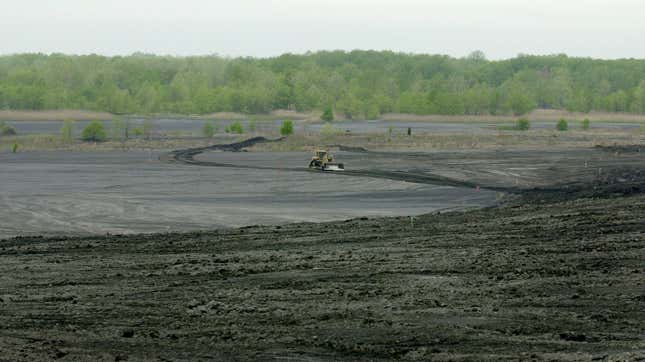 A piece of Koester Contracting’s earth moving equipment moves material Wednesday, April 24, 2002 from the hills of black coal waste byproduct at the processing site outside Lynnville, Indiana.