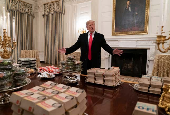 BURGER KINGPIN: Donald Trump presents fast food to be served to the Clemson Tigers football team to celebrate their Championship at the White House on Jan. 14, 2019, in Washington, D.C.