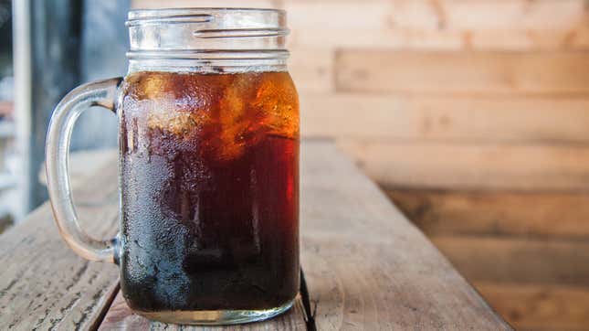 A cup of iced coffee on a wooden table