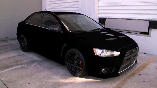 Image for article titled This Impossibly Black Lancer Evolution Uses Special Paint To Break Your Brain