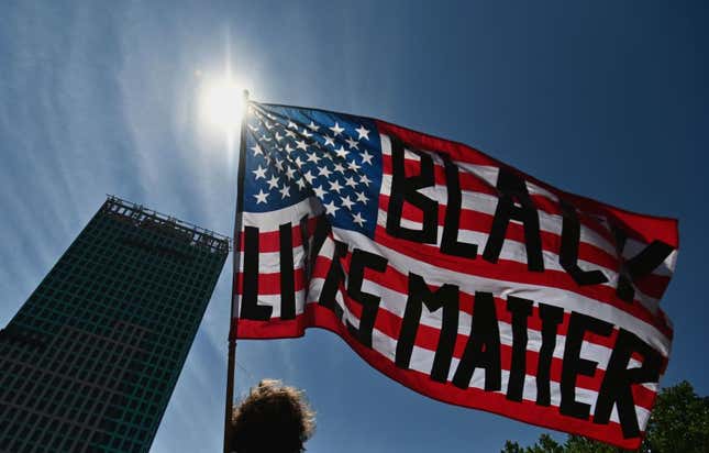 A protestor waves an American flag with the words “Black Lives Matter” painted on it during a Juneteenth rally at Cadman Plaza on June 19, 2020 in the Brooklyn Borough of New York City.