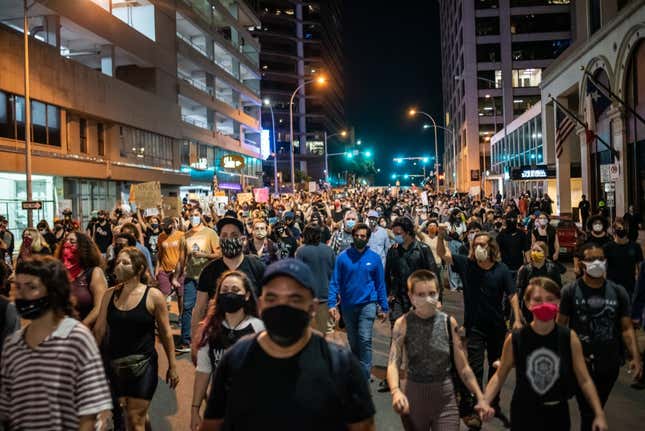 People walk down 7th street in Austin after a vigil for Garrett Foster on July 26, 2020 in downtown Austin, Texas. Garrett Foster, 28, who was armed and participating in a Black Lives Matter protest, was shot and killed after a chaotic altercation with a motorist who allegedly drove into the crowd. The suspect, who has yet to be identified, was taken into custody. 