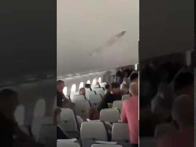 Holy Crap Check Out This Guy Going Berserk on an Airline Flight From Australia to Singapore