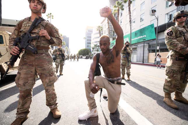 A demonstrator kneels during a march in response to George Floyd’s death on June 2, 2020, in Los Angeles, California.