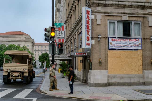  A National Guardsman speaks to a pedestrian outside of Harry’s Bar near the White House in Washington, DC