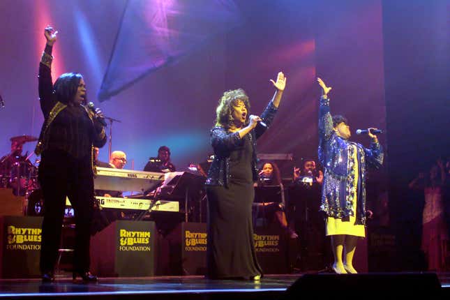 Pamela Hutchinson, center, alongside sisters Sheila and Wanda performing onstage as The Emotions at the Apollo Theatre in New York City in November 2001. 