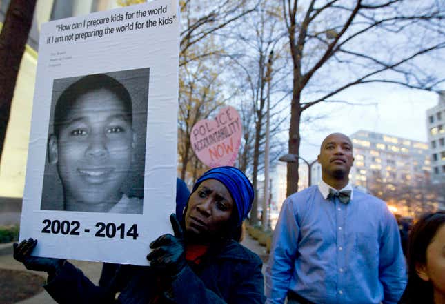 Tomiko Shine holds up a picture of Tamir Rice, the 12-year-old boy fatally shot on Nov. 22 by a rookie police officer, during a protest in Ferguson, Mo.