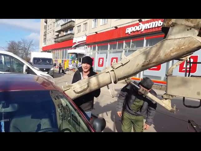 Here Is A Russian Man Filling A Car With Concrete