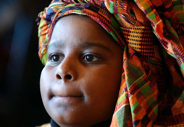 Symba Nureddin, 9, watches the festivities during a Kwanzaa festival at the Museum of Natural History Dec.28, 2002, in New York City. 